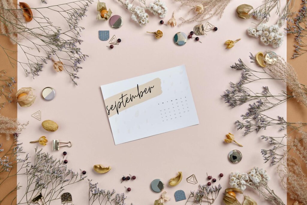 Printed September Calendar Paper Surrounded by Dried Flowers