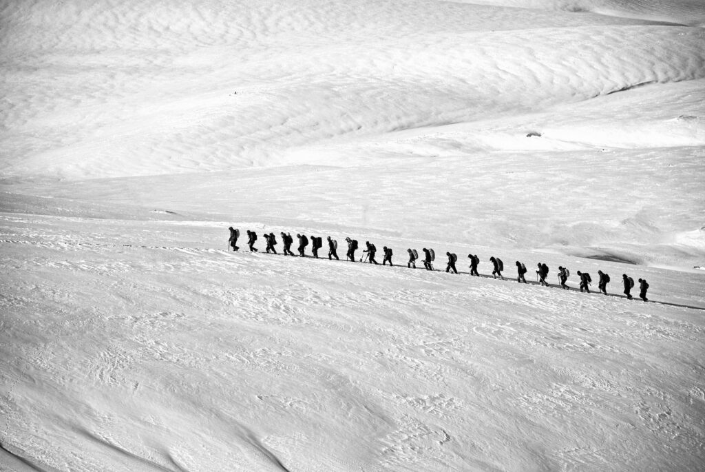 People Walking on Snow Field Grayscale Photography